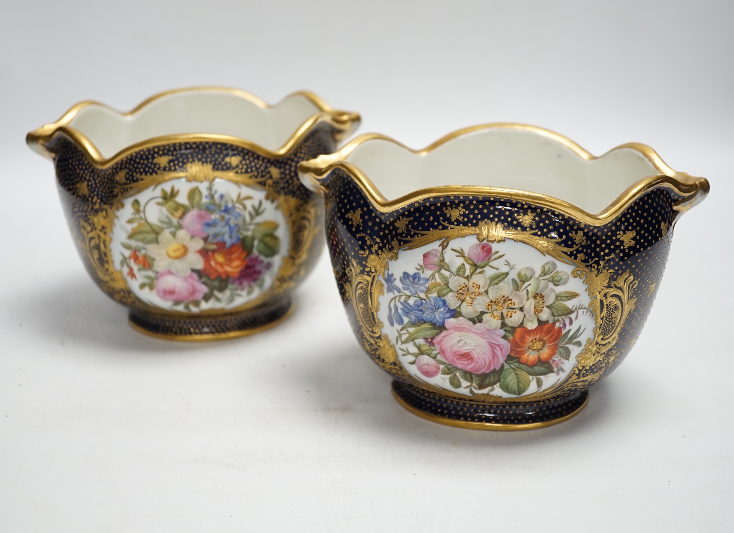 A pair of 19th century Paris porcelain cache pot hand painted with flowers and gilded decoration, 12cm high